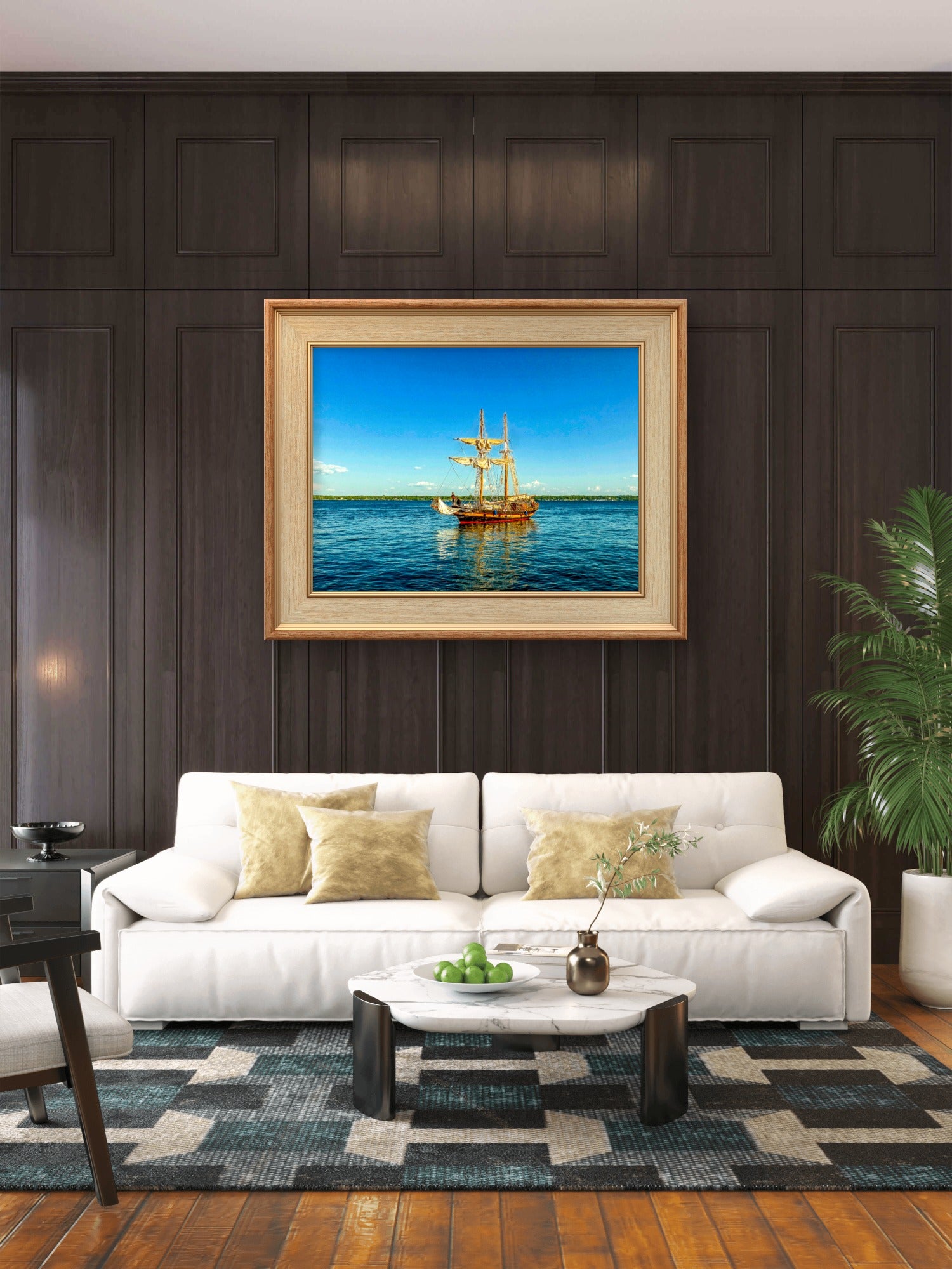 A framed painting of a golden sailing ship on a blue ocean, displayed on a dark wood paneled wall above a modern white sofa in a living room setting.